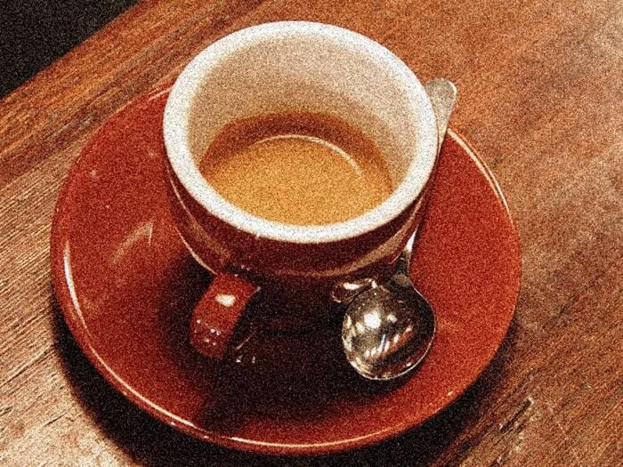 A cup of espresso on a saucer.