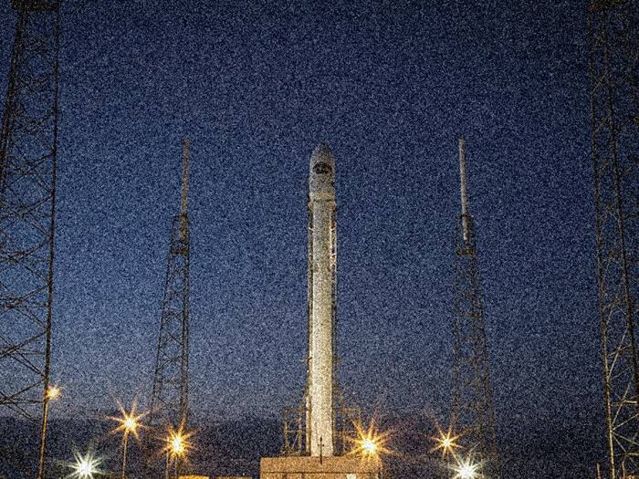 A rocket on its launch pad before dawn.