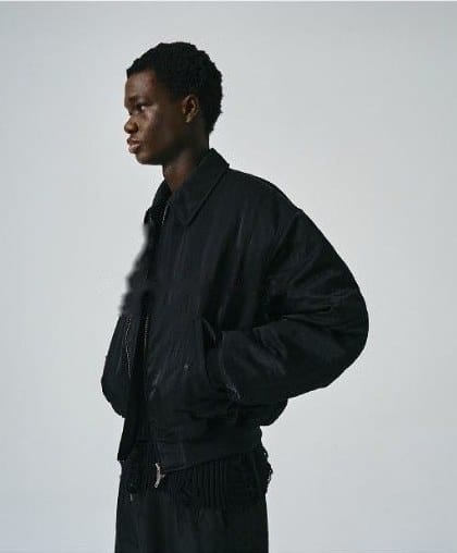 Reference portrait: a man in profile against a grey wall.